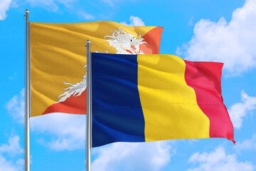 Romania and Bhutan national flag waving in the windy deep blue sky. Diplomacy and international relations concept.