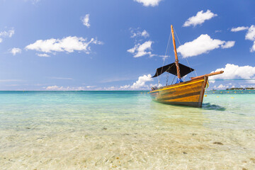 Fototapeta na wymiar A boat anchored in the bay of Cap Malheureux, Riviere Du Rempart, Mauritius