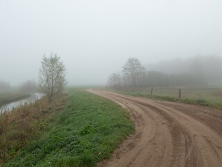 Fototapeta na wymiar Dirt road in fog