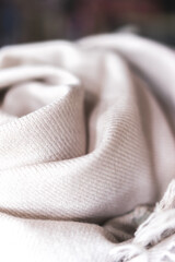 close up of a cashmere scarf, pink fabric, piece of clothing, woolen texture, clothing material, soft pink blanket