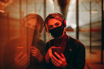 Girl with protective mask and cellphone.