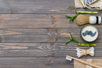 Zero waste bathroom accessories on wooden background. Natural eco bamboo product. Plastic free beauty essentials.