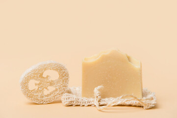 Handmade soap and loofah sponges on a beige background. Eco lifestyle concept...