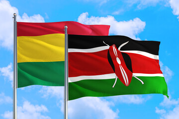 Kenya and Bolivia national flag waving in the windy deep blue sky. Diplomacy and international relations concept.