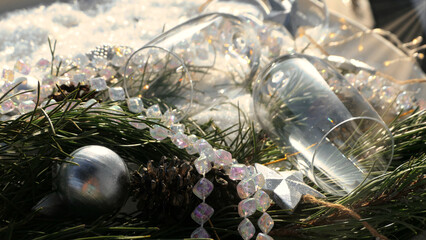 macro of festive champagne glasses with silver iridescent decoration with snow
