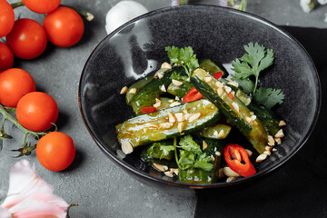 Salad of broken cucumbers with sesame seeds, sugar, red and black pepper, olive oil