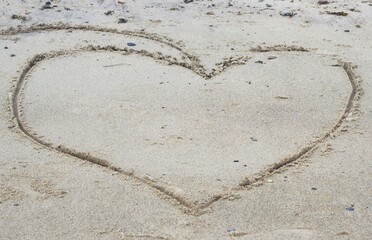 Image of love, drawing of a heart in the sand