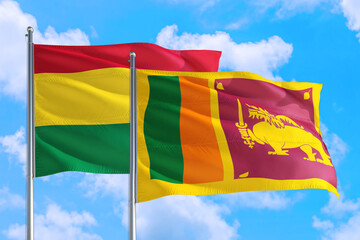 Sri Lanka and Bolivia national flag waving in the windy deep blue sky. Diplomacy and international relations concept.