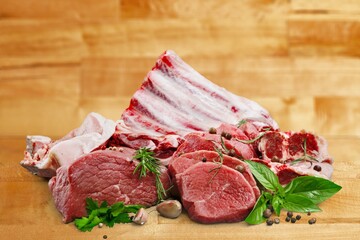 Collections fresh raw meat with spices on the desk