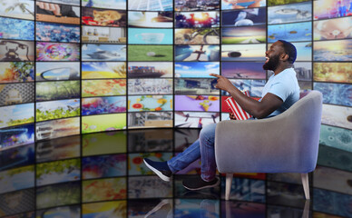 Man has fun watching a film. Concept of entertainment and streaming tv. red background