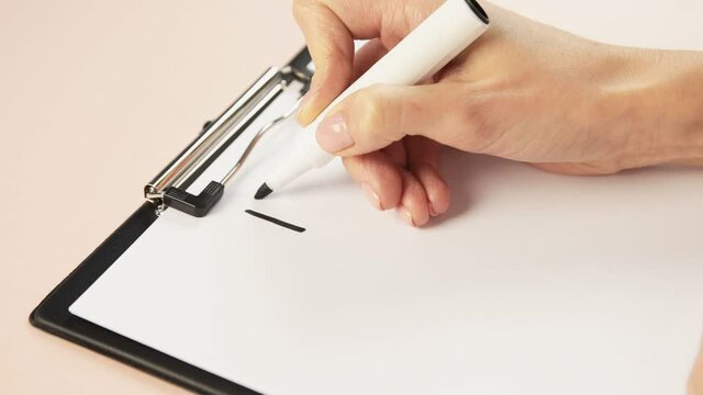 Conceptual photo. A clipboard on a beige background, sheet a4 on which the word idea is written with marker. 
