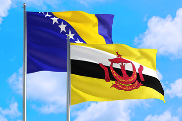 Brunei and Bosnia Herzegovina national flag waving in the windy deep blue sky. Diplomacy and international relations concept.