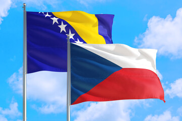Czech Republic and Bosnia Herzegovina national flag waving in the windy deep blue sky. Diplomacy...