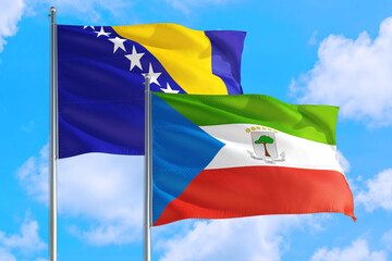 Equatorial Guinea and Bosnia Herzegovina national flag waving in the windy deep blue sky. Diplomacy and international relations concept.