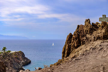 Fototapeta na wymiar The west coast of Tenerife on whose rugged cliffs the place Puerto de Santiago nestles. The impressive landscape of rugged rocks and the endless expanse of the sea. 