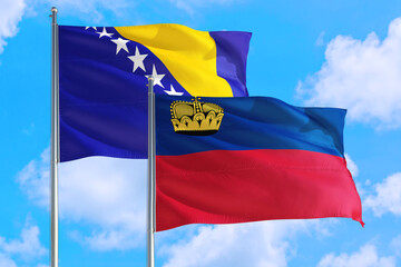 Liechtenstein and Bosnia Herzegovina national flag waving in the windy deep blue sky. Diplomacy and international relations concept.