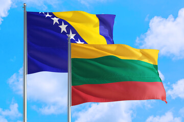 Lithuania and Bosnia Herzegovina national flag waving in the windy deep blue sky. Diplomacy and international relations concept.