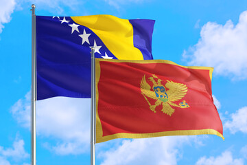 Montenegro and Bosnia Herzegovina national flag waving in the windy deep blue sky. Diplomacy and...