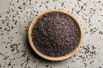 Black salt on grey table, flat lay