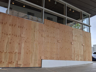 boarded up windows and doors in a downtown building during protests and riots