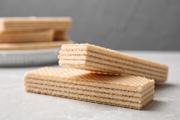 Delicious cream wafers on light grey marble table, closeup