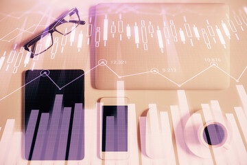 Multi exposure of financial chart hologram over desktop with phone. Top view. Mobile trade platform concept.