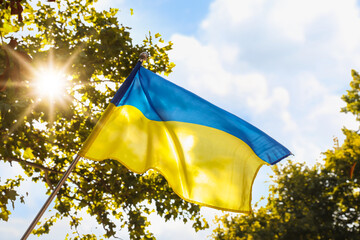 National flag of Ukraine fluttering on sunny day outdoors