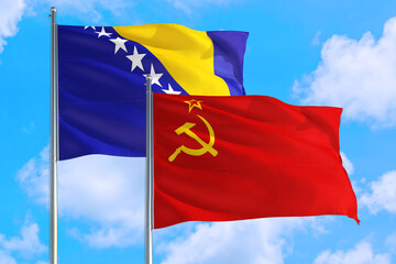 Soviet Union and Bosnia Herzegovina national flag waving in the windy deep blue sky. Diplomacy and...