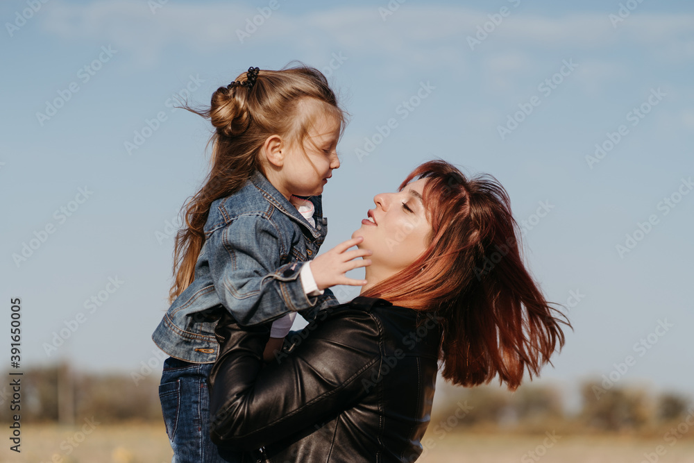 Wall mural mother walking outdoors with her little daughter