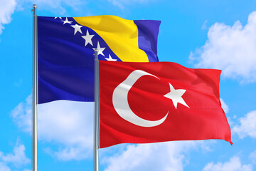 Turkey and Bosnia Herzegovina national flag waving in the windy deep blue sky. Diplomacy and...