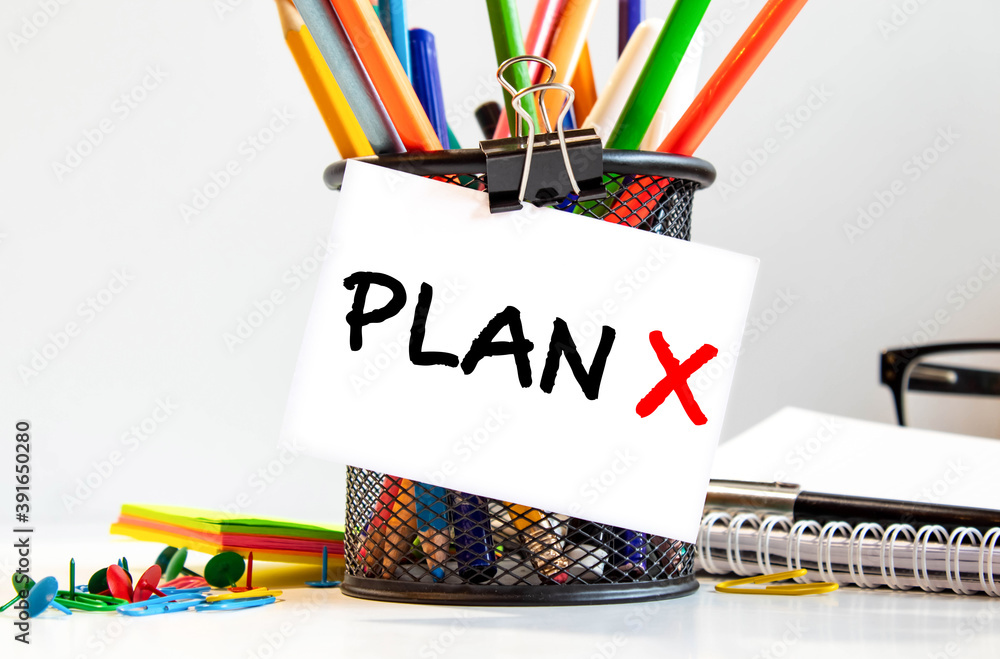 Poster plan x text on paper in open diary with spectacles,