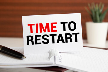 businesswoman holding a black paper plate with text TIME TO RESTART