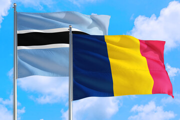 Chad and Botswana national flag waving in the windy deep blue sky. Diplomacy and international relations concept.