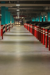 Metal parking guardrails red posts, concrete road for safe movement of pedestrians in the parking...