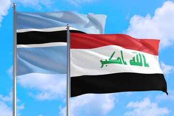 Iraq and Botswana national flag waving in the windy deep blue sky. Diplomacy and international...