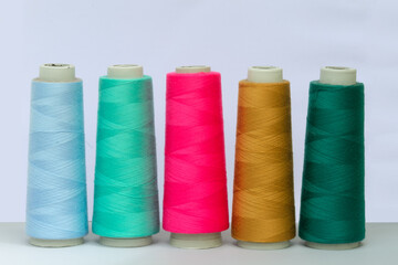Closeup shot of colorful thread rolls in a line