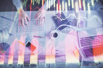 Double exposure of man and woman working together and financial chart hologram drawing. market...