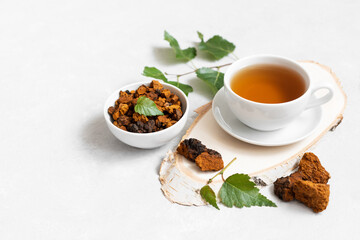Chaga tea on a white background. Useful infusion of birch mushrooms. Drink to boost immunity.