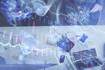 Double exposure of man and woman working together and financial chart hologram drawing. market analysis concept. Computer background. Top View.