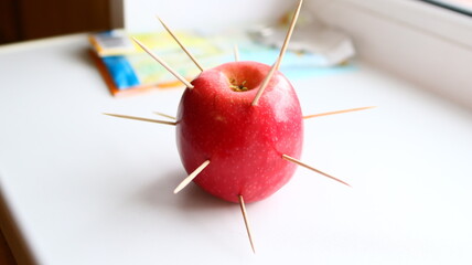 red apple with a needle