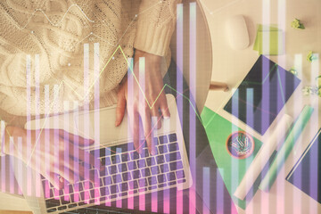 Multi exposure of woman hands working on computer and forex chart hologram drawing. Top View. Financial analysis concept.