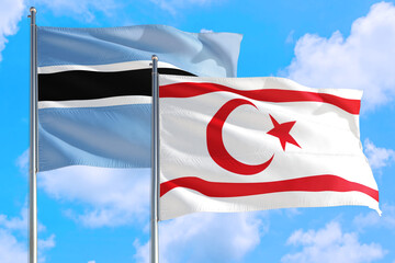 Northern Cyprus and Botswana national flag waving in the windy deep blue sky. Diplomacy and international relations concept.