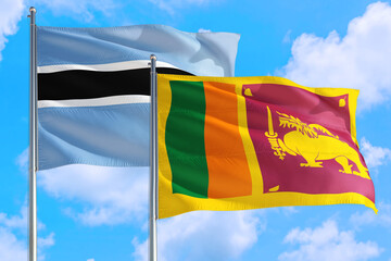 Sri Lanka and Botswana national flag waving in the windy deep blue sky. Diplomacy and international relations concept.