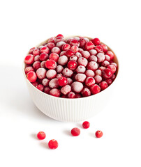 Frozen cranberries in a bowl isolated on a white background. Frozen red berries closeup.