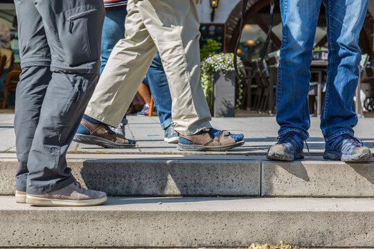 KOBLENZ, GERMANY - Sep 19, 2020: Legs Of A Group Of Men Standing Too Close Together, No Sufficient Distance To Prevent Corona