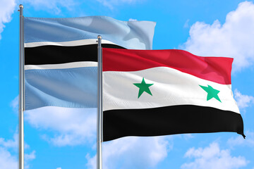 Fototapeta na wymiar Syria and Botswana national flag waving in the windy deep blue sky. Diplomacy and international relations concept.