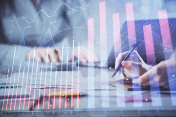 Multi exposure of woman hands typing on computer and forex chart hologram drawing. Stock market...