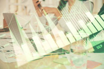 Multi exposure of woman hands typing on computer and forex chart hologram drawing. Stock market analysis concept.