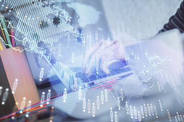 Obraz premium Double exposure of woman hands typing on computer and forex chart hologram drawing. Stock market invest concept.