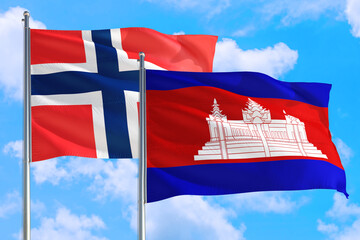Cambodia and Bouvet Islands national flag waving in the windy deep blue sky. Diplomacy and...